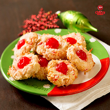 Sweet maraschino cherry and coconut cookies served on santa plate