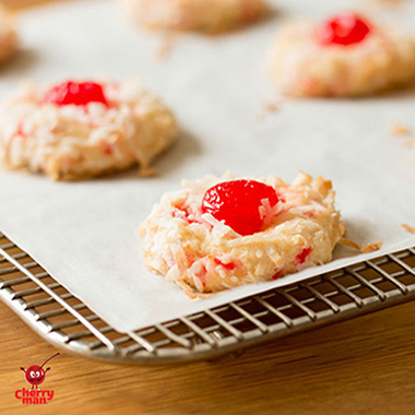 Coconut cookies with tasty bright red cherries