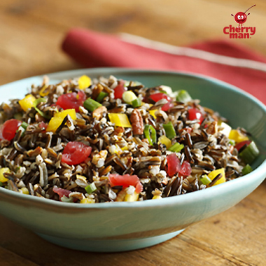Wild rice salad with ibrant colors of maraschino cherries, bell pepper, and onion.
