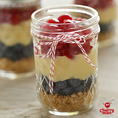 healthy homemade pudding parfait with layers of blueberries and cherries.